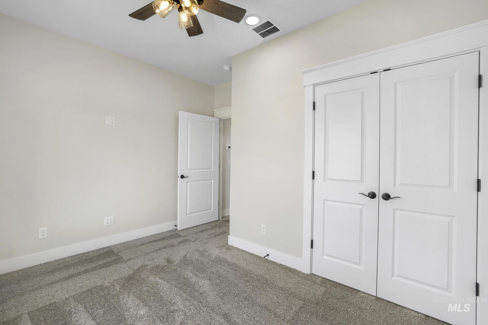 1441 Haizlee Way Twin Falls, ID 83301 - Photo 18 of 26 Unfurnished bedroom featuring carpet floors, a closet, and ceiling fan