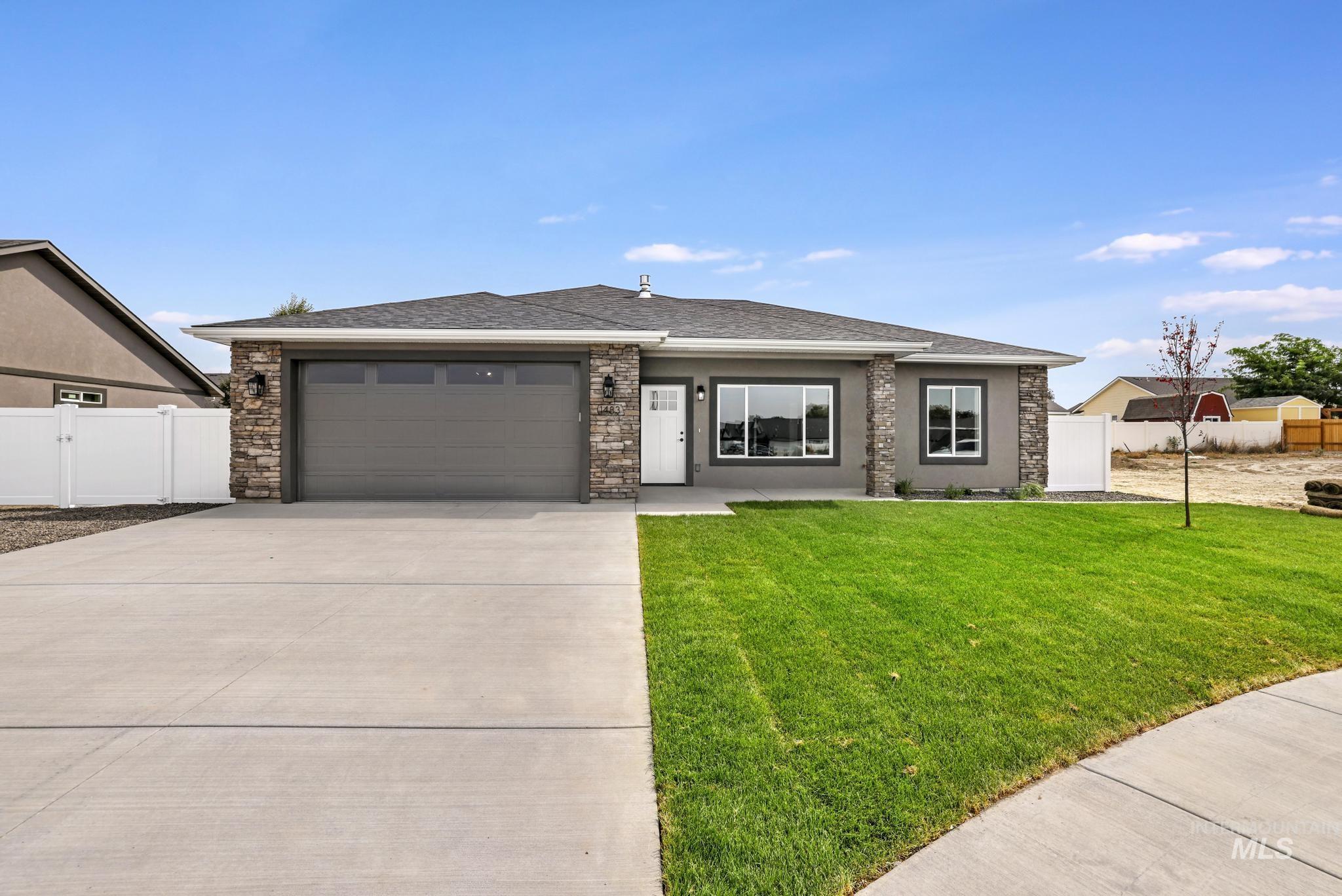 1441 Haizlee Way Twin Falls, ID 83301 - Photo 25 of 26 Prairie-style house featuring an attached garage, roof with shingles, concrete driveway, and a gate