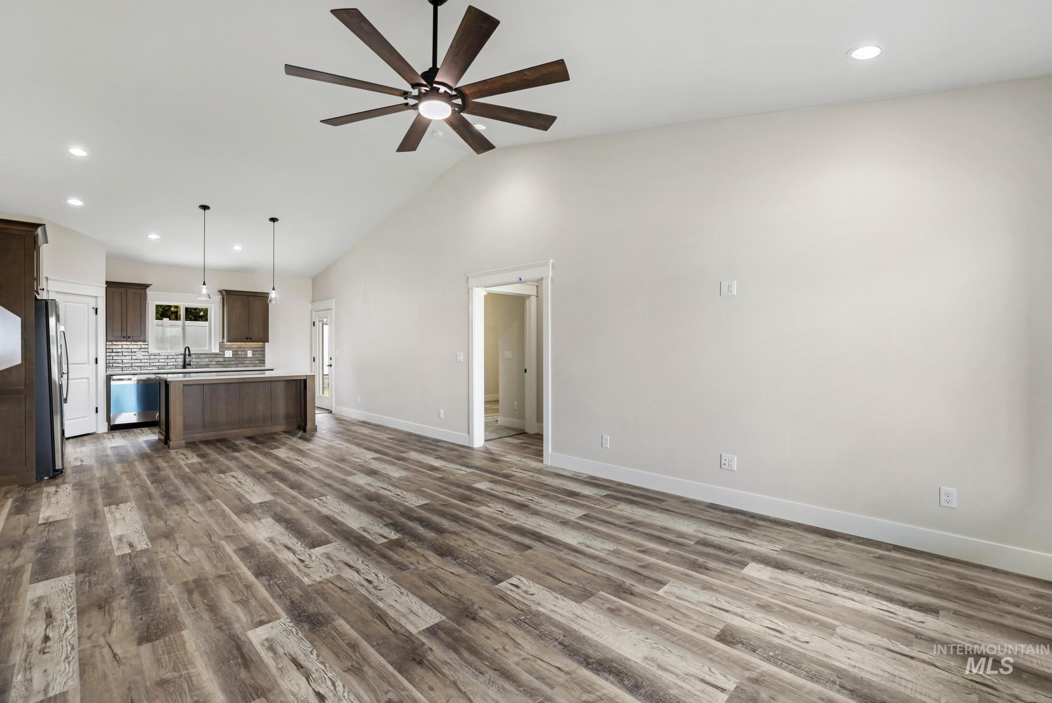 1441 Haizlee Way Twin Falls, ID 83301 - Photo 6 of 26 Unfurnished living room featuring recessed lighting, dark wood-style flooring, lofted ceiling, and ceiling fan
