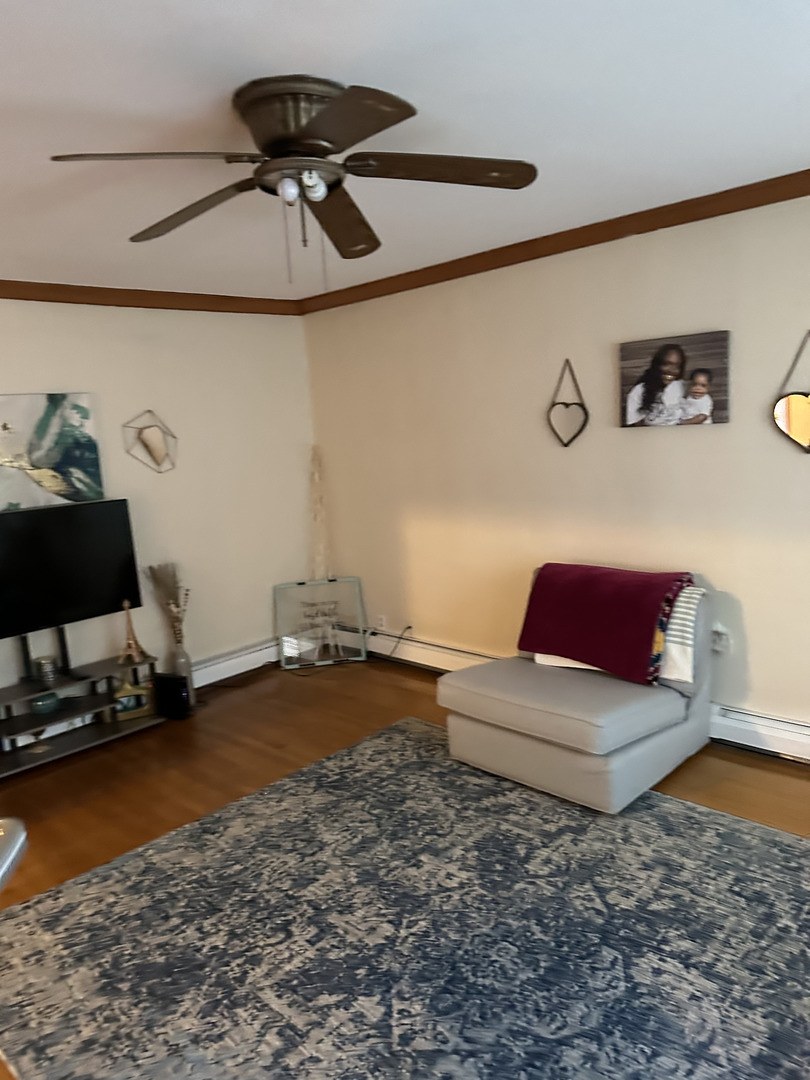 309 Ridgeland Avenue Elmhurst, IL 60126 - Photo 2 of 8 a living room with furniture and a rug