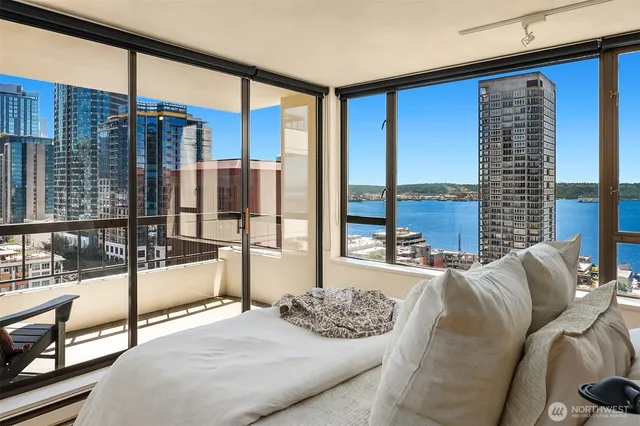 a bedroom with furniture and a floor to ceiling window