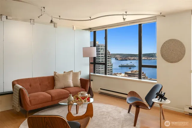 a living room with furniture a window and a chandelier