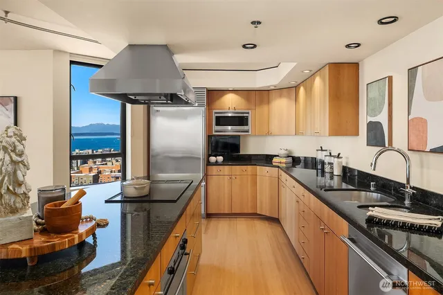 a kitchen with granite countertop a stove and a sink