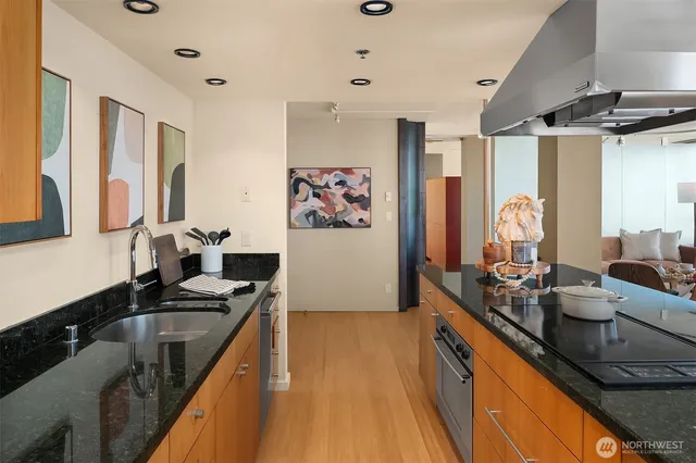 a kitchen with stainless steel appliances a sink stove and refrigerator
