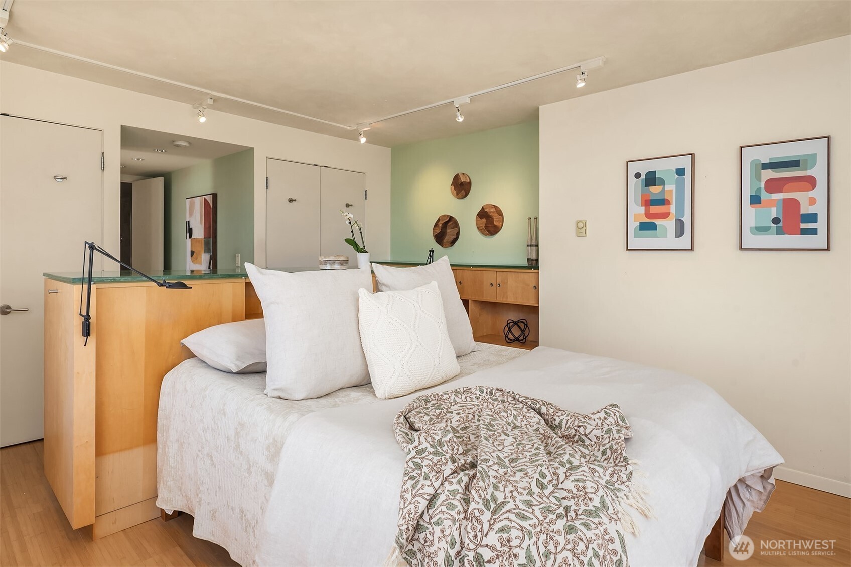 2201 3rd Avenue, Unit 2003 Seattle, WA 98121 - Photo 27 of 38 a bedroom with a bed and wooden floor