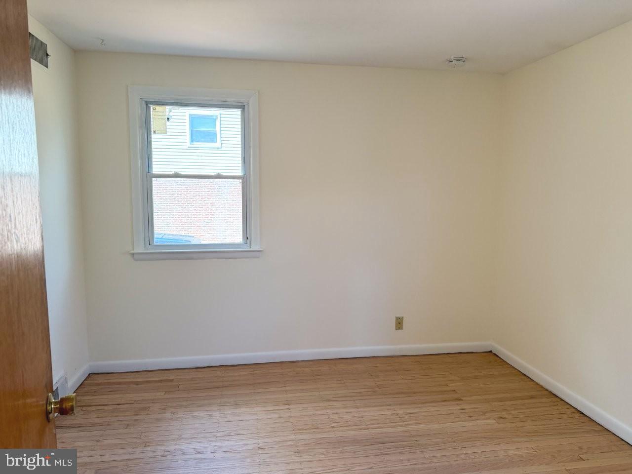 637 North Bishop Avenue Springfield, PA 19064 - Photo 33 of 51 a view of an empty room with wooden floor and a window