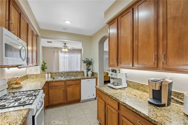 a kitchen with stainless steel appliances granite countertop a sink stove and cabinets