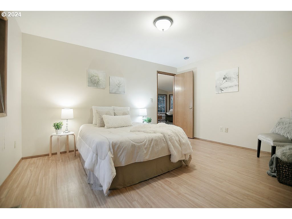 59 Whitewater Road Longview, WA 98632 - Photo 23 of 39 a bedroom with a bed and wooden floor