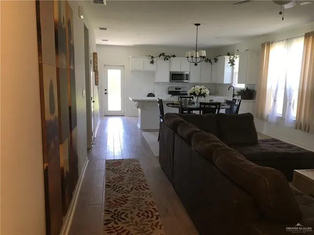 a living room with furniture and a chandelier
