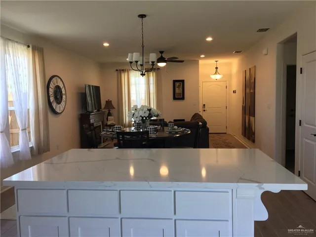 a view of a dining room with furniture and chandelier