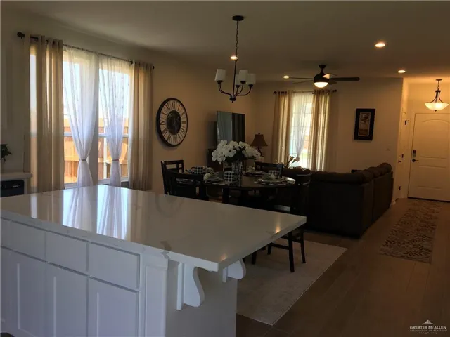 a view of a dining room with furniture and chandelier