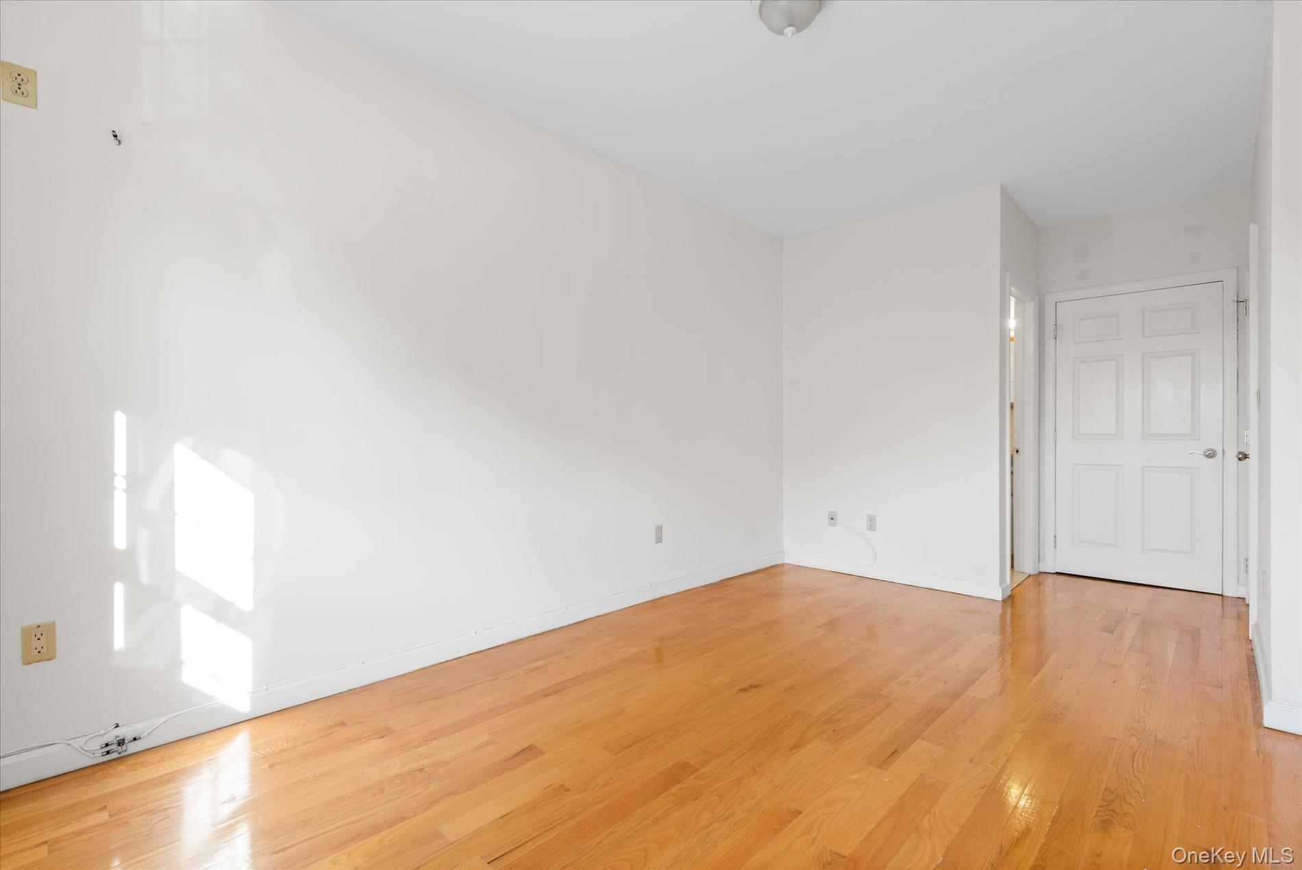 71-05 Cooper Avenue, Unit 2 Queens, NY 11385 - Photo 12 of 15 Spare room featuring light wood-style flooring and baseboards