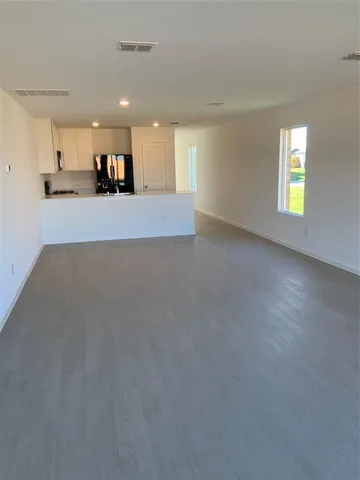 a view of a kitchen with furniture and a window