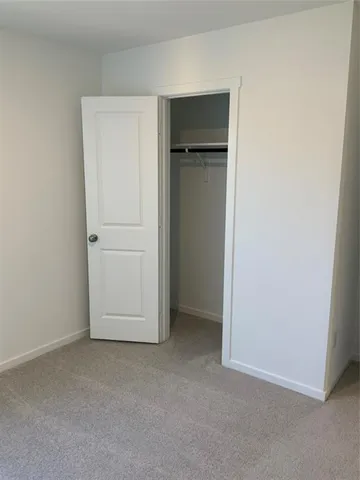 an empty room with closet area