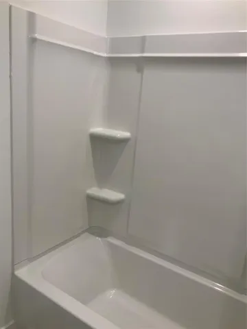 a white toilet sitting next to a white sink and vanity