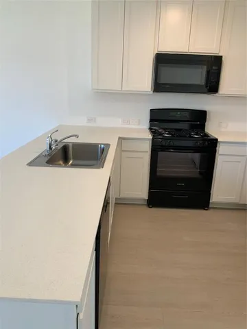 a kitchen with a stove and a microwave