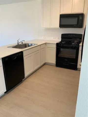 a kitchen with a stove and a microwave