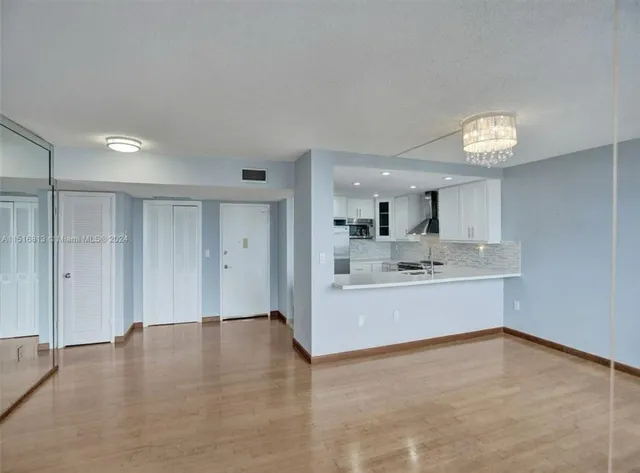 a view of kitchen with granite countertop cabinets and sink