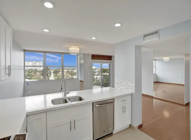 a kitchen with counter top space sink and center island