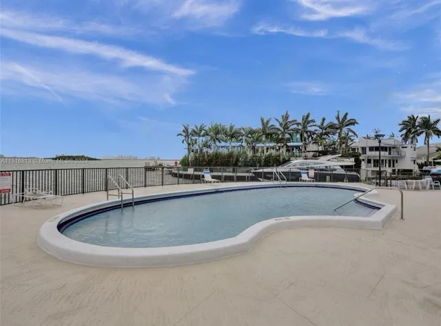 a view of swimming pool with outdoor seating and yard in back