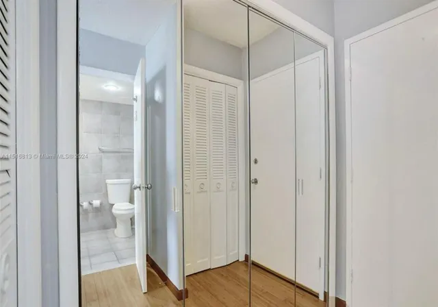a bathroom with a glass shower door and a toilet