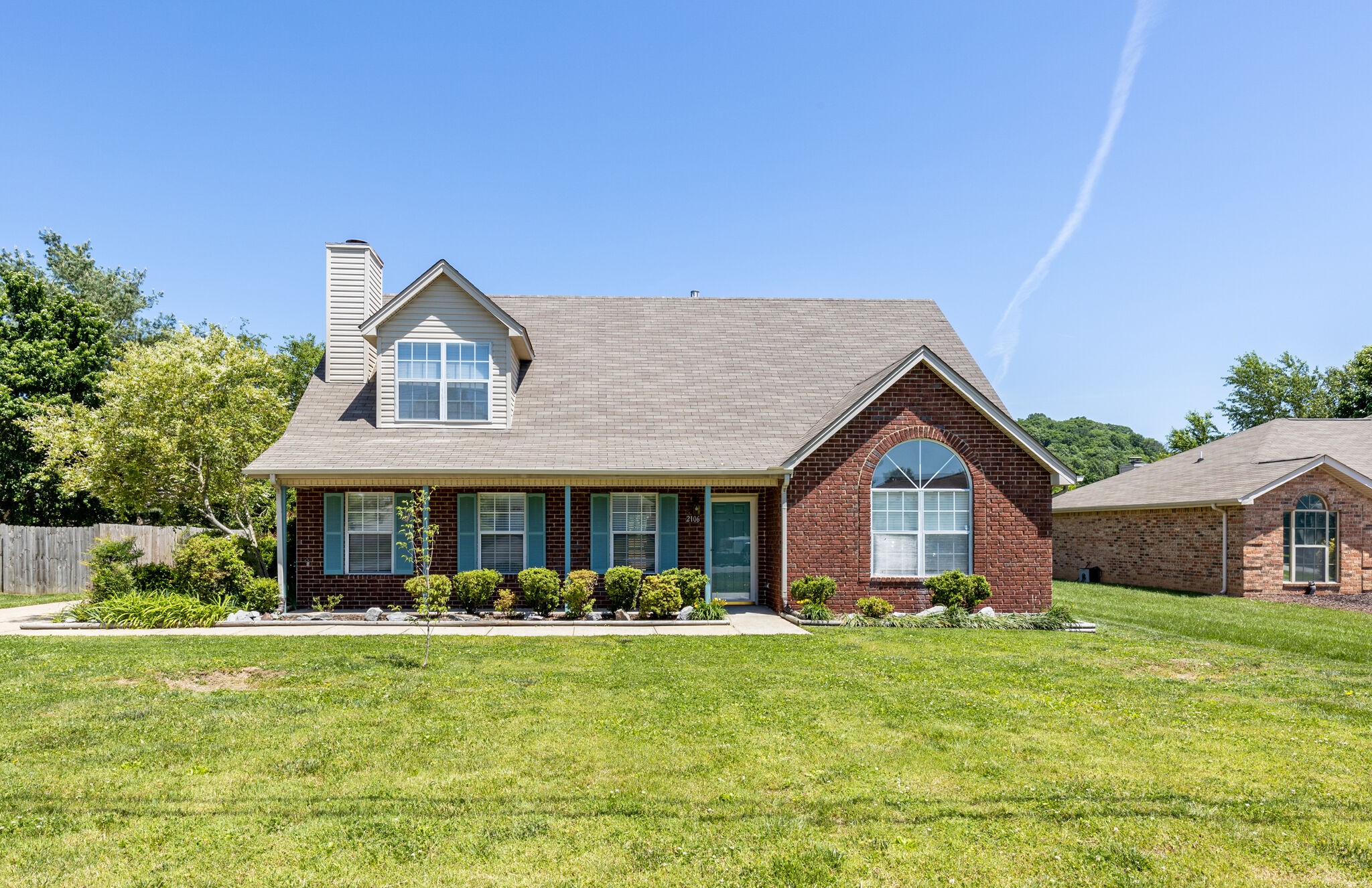 2106 Spring Hill Circle Spring Hill, TN 37174 - Photo 1 of 38 a front view of a house with a yard table and chairs