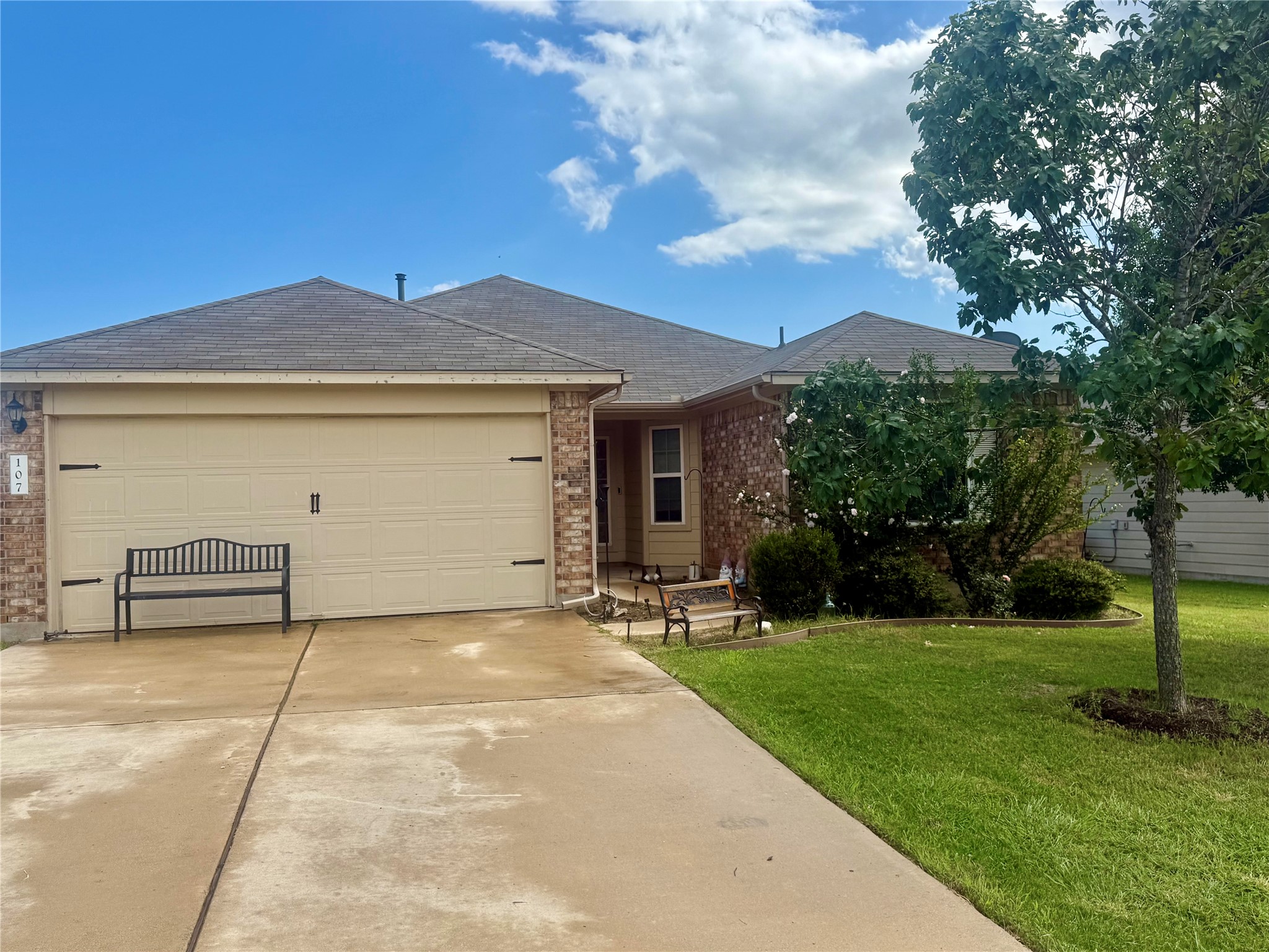 107 Jim Dandy Drive Elgin, TX 78621 - Photo 1 of 15 A classic brick exterior offers charm and curb appeal.