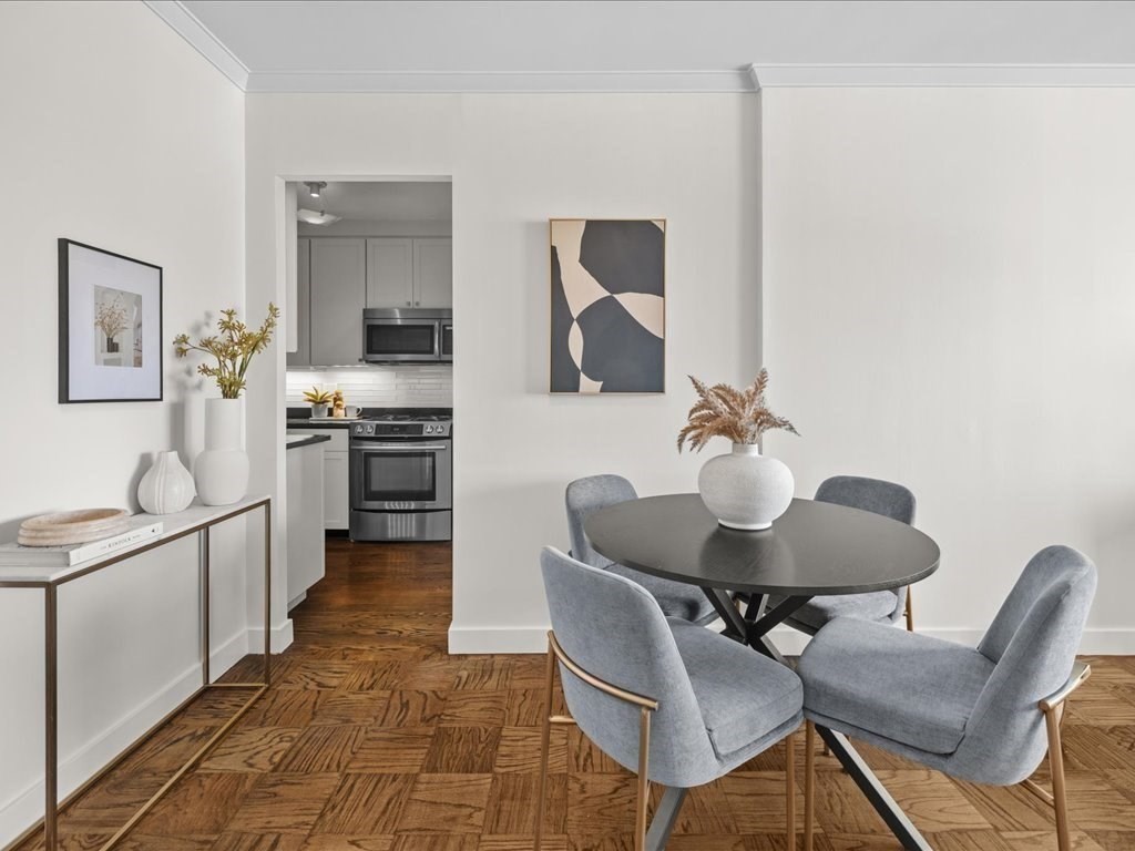 65 East India Row, Unit 33A Boston, MA 02110 - Photo 18 of 36 a kitchen with granite countertop sink stove and chairs
