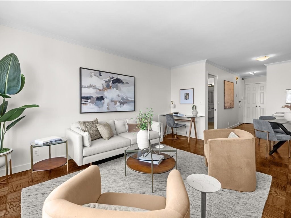 65 East India Row, Unit 33A Boston, MA 02110 - Photo 19 of 36 a living room with furniture and a painting on the wall