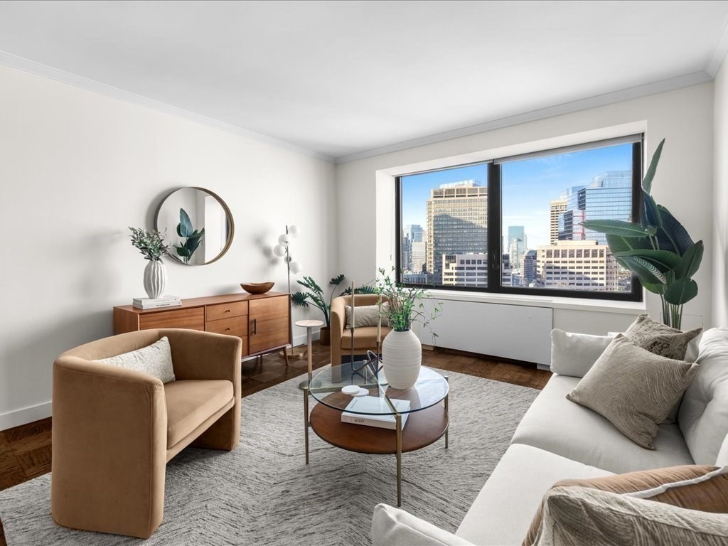 65 East India Row, Unit 33A Boston, MA 02110 - Photo 20 of 36 a living room with furniture and a large window
