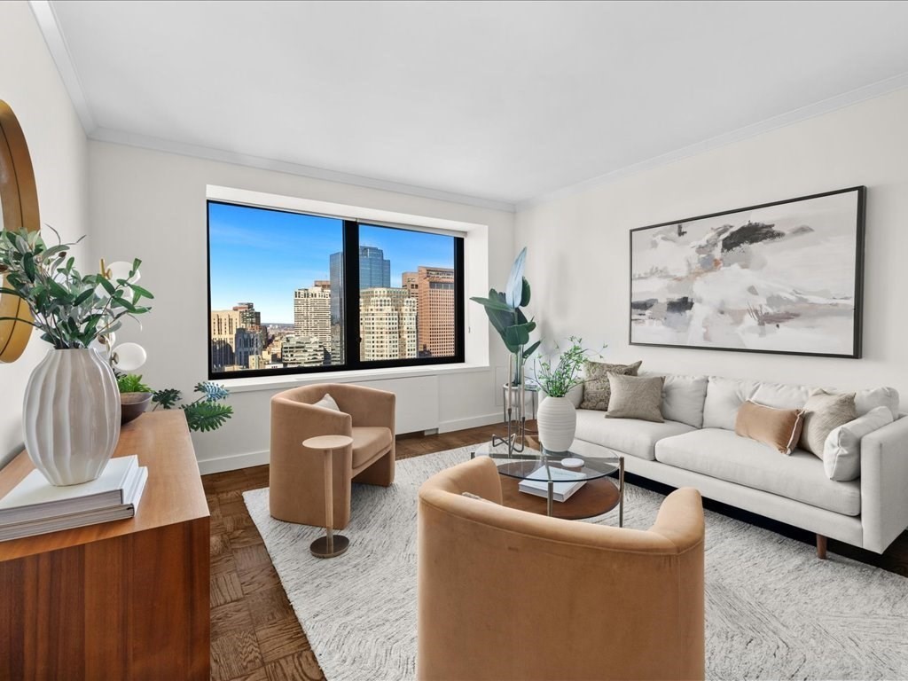 65 East India Row, Unit 33A Boston, MA 02110 - Photo 2 of 36 a living room with furniture and a painting on the wall