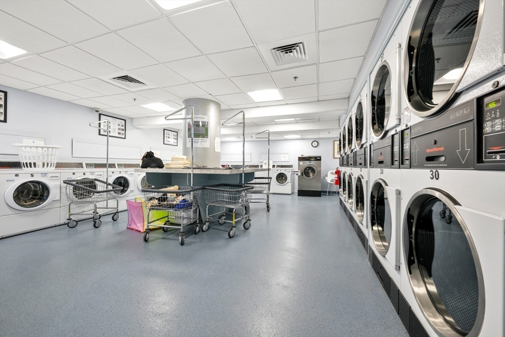 65 East India Row, Unit 33A Boston, MA 02110 - Photo 27 of 36 a view of a storage and utility room with washer and dryer