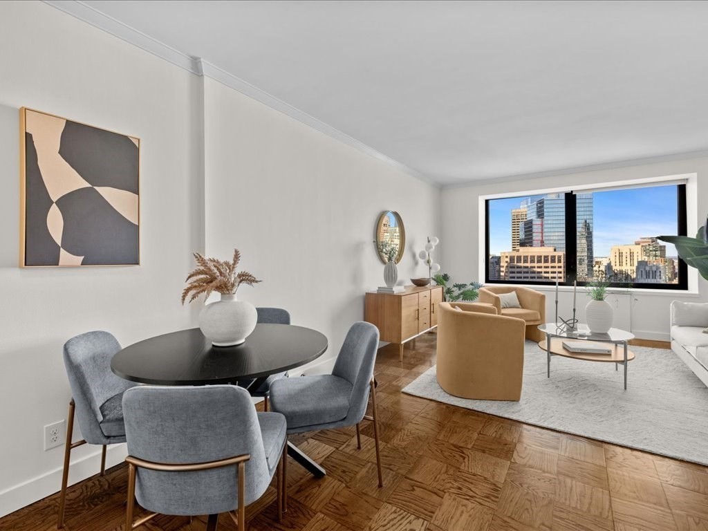 65 East India Row, Unit 33A Boston, MA 02110 - Photo 3 of 36 a living room with furniture a rug and a view of kitchen