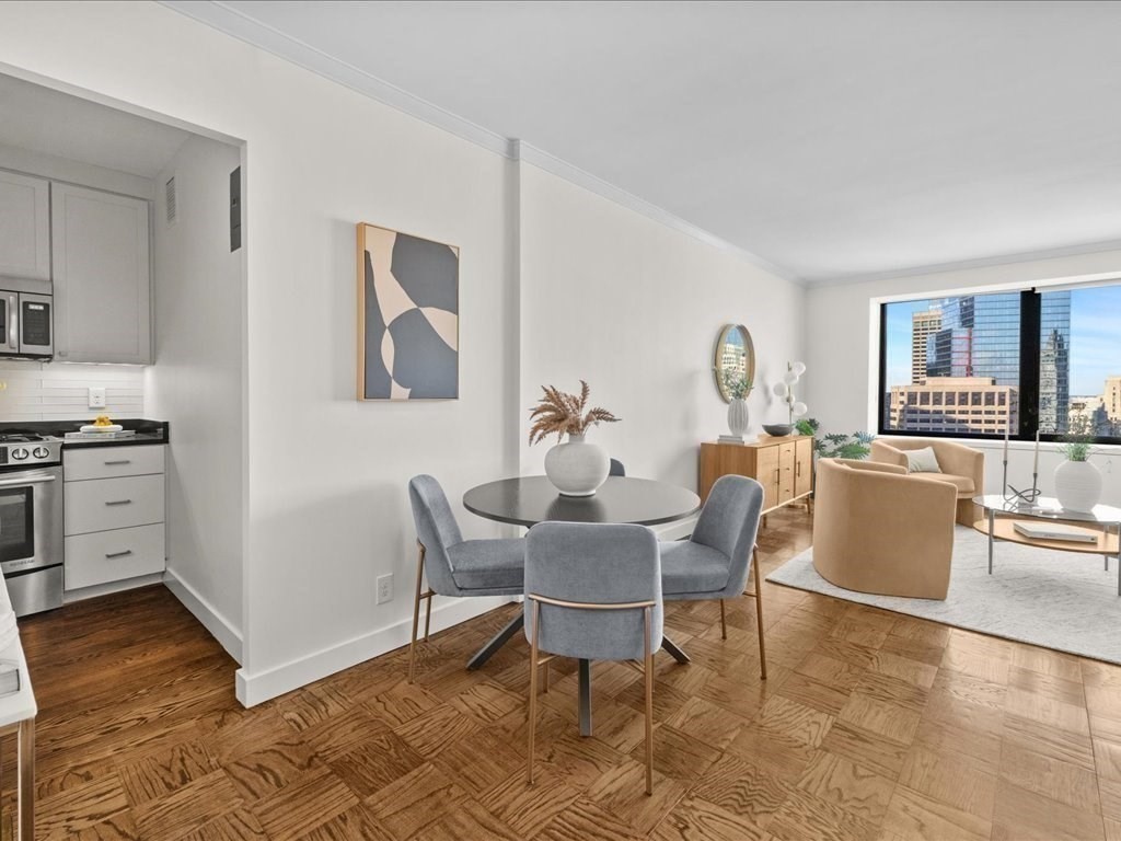 65 East India Row, Unit 33A Boston, MA 02110 - Photo 7 of 36 a view of a dining room with furniture and wooden floor