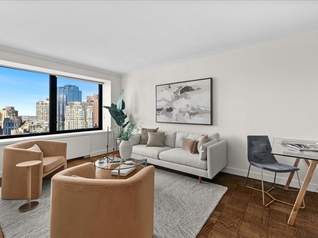 65 East India Row, Unit 33A Boston, MA 02110 - Photo 8 of 36 a living room with furniture and a large window