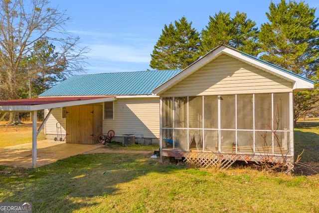 a view of a porch with chairs and backyard