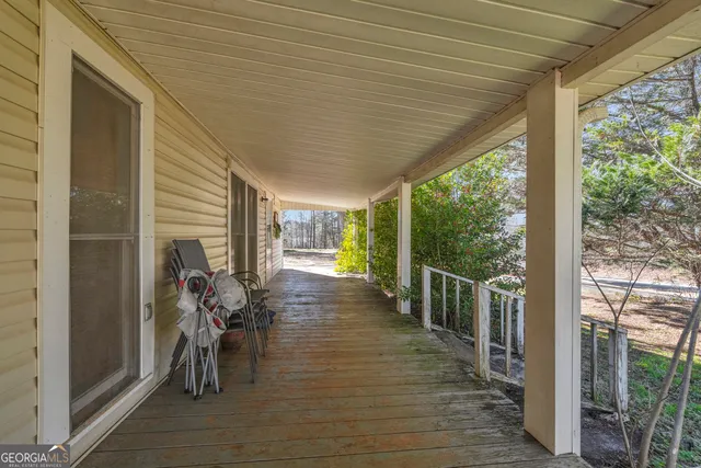 a view of a glass door with a tree in the background