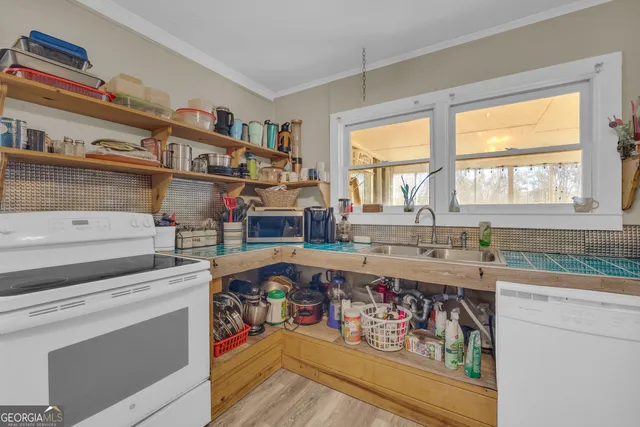 a large bedroom with a large bed and a chandelier