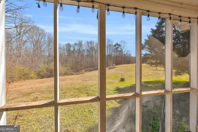 a view of empty room with window and ceiling fan