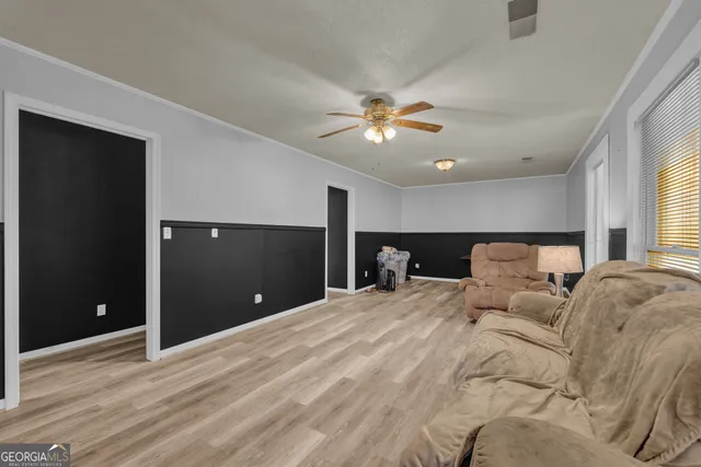 a view of a hallway with wooden floor and a bedroom