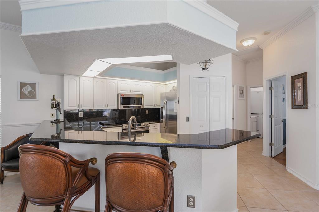 48 Bunker Road Rotonda West, FL 33947 - Photo 19 of 59 a kitchen with stainless steel appliances granite countertop a sink refrigerator and cabinets
