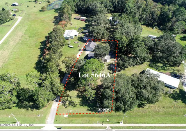 a view of a house with a yard covered with snow in the background