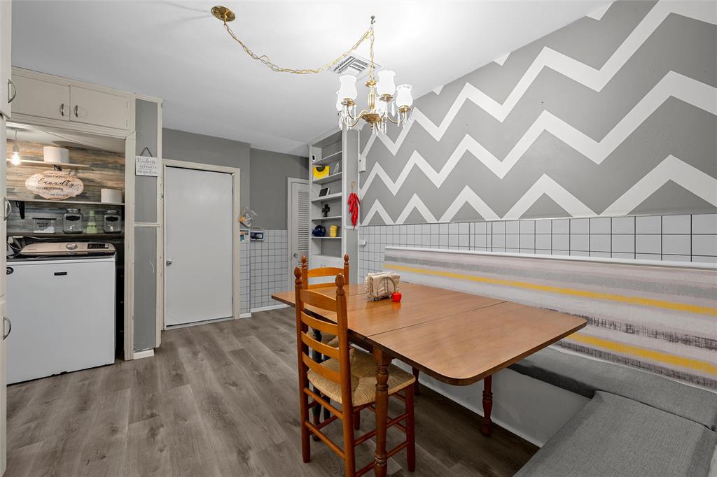 301 North 40th Street Waco, TX 76710 - Photo 8 of 26 Dining area featuring wood-finish flooring and a built-in upholstered bench