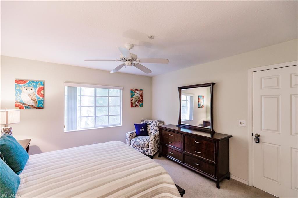 320 Gabriel Circle, Unit 3608 Naples, FL 34104 - Photo 11 of 32 a bedroom with a bed and a dresser