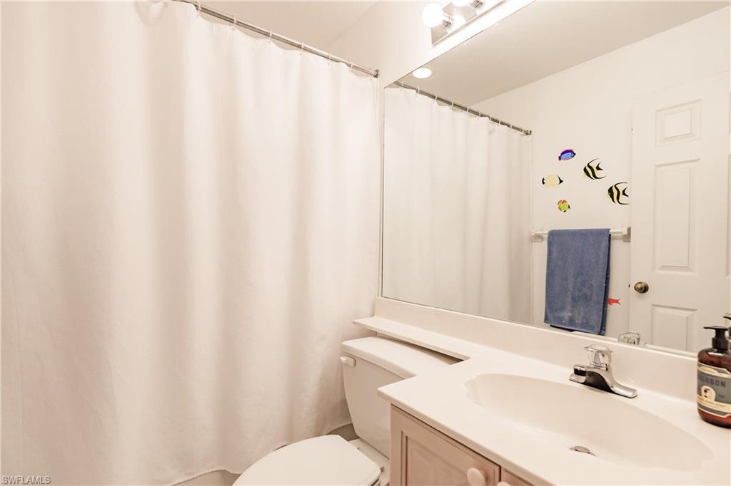 320 Gabriel Circle, Unit 3608 Naples, FL 34104 - Photo 14 of 32 a bathroom with a sink and a mirror