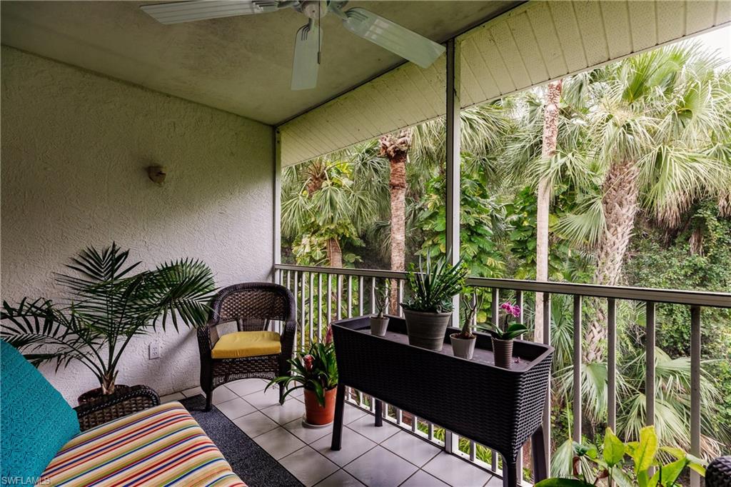 320 Gabriel Circle, Unit 3608 Naples, FL 34104 - Photo 19 of 32 a balcony with wooden floor and outdoor seating