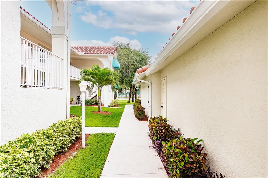 320 Gabriel Circle, Unit 3608 Naples, FL 34104 - Photo 21 of 32 a front view of a house with a yard