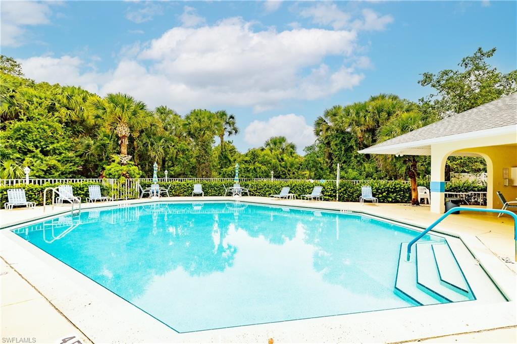 320 Gabriel Circle, Unit 3608 Naples, FL 34104 - Photo 24 of 32 a view of a swimming pool with a lounge chair