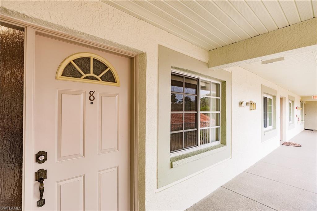 320 Gabriel Circle, Unit 3608 Naples, FL 34104 - Photo 3 of 32 a front view of a house with a yard