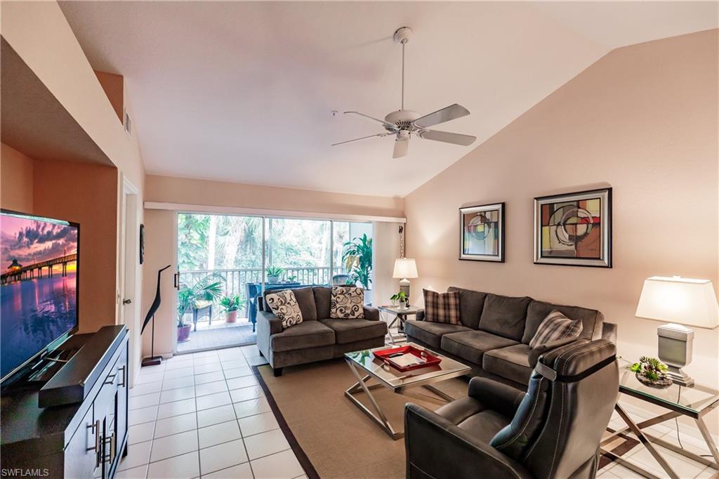 320 Gabriel Circle, Unit 3608 Naples, FL 34104 - Photo 4 of 32 a living room with furniture and a flat screen tv